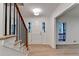 Open foyer with wood-look floors, white walls, and stairs with black iron railings at 315 N Fayette Dr, Fayetteville, GA 30214