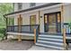 Inviting front porch with black railings and natural wood posts, a cozy entryway at 315 N Fayette Dr, Fayetteville, GA 30214