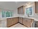 Spacious kitchen with stainless appliances, updated countertops, and view of trees at 315 N Fayette Dr, Fayetteville, GA 30214