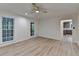Light-filled living room boasts new floors, fresh paint, and fan fixture at 315 N Fayette Dr, Fayetteville, GA 30214
