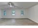 Spacious living room featuring three windows and modern ceiling fan at 315 N Fayette Dr, Fayetteville, GA 30214