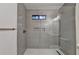 Modern glass shower with gray tile, niche, and bronze fixtures at 315 N Fayette Dr, Fayetteville, GA 30214