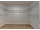 Walk-in closet featuring wood-look flooring and custom wire shelving at 315 N Fayette Dr, Fayetteville, GA 30214