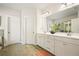 Bathroom features a tiled shower, and a double sink vanity with a large mirror at 383 Crestbrook Ln, Dallas, GA 30157