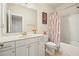 Bathroom featuring a vanity with a sleek mirror, a toilet, and a shower-tub combo with stylish shower curtain at 383 Crestbrook Ln, Dallas, GA 30157
