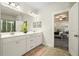 Bright bathroom featuring double vanity sinks and a tiled shower at 383 Crestbrook Ln, Dallas, GA 30157