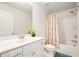 Bathroom featuring a vanity with a sleek mirror, a toilet, and a shower-tub combo with stylish shower curtain at 383 Crestbrook Ln, Dallas, GA 30157