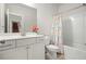 Bathroom featuring a vanity with a sleek mirror, a toilet, and a shower-tub combo with stylish shower curtain at 383 Crestbrook Ln, Dallas, GA 30157