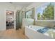Bright bathroom with a soaking tub, tiled shower, and large window at 383 Crestbrook Ln, Dallas, GA 30157