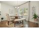 Bright dining area featuring hardwood floors, a round table, padded chairs, and a window view at 383 Crestbrook Ln, Dallas, GA 30157