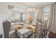 Formal dining room with hardwood floors, decorative chandelier, table setting and many windows for plenty of light at 383 Crestbrook Ln, Dallas, GA 30157