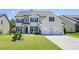 Beautiful two-story home with a manicured lawn, a two-car garage, and a classic brick facade at 383 Crestbrook Ln, Dallas, GA 30157