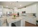 Gourmet kitchen with stainless steel appliances, white cabinets, granite countertops, and a spacious center island at 383 Crestbrook Ln, Dallas, GA 30157