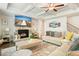 Cozy living room with stone fireplace, modern decor, coffered ceiling, and large windows at 383 Crestbrook Ln, Dallas, GA 30157