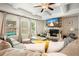 Inviting living room with a stone fireplace, coffered ceiling, large windows, and a comfortable sofa at 383 Crestbrook Ln, Dallas, GA 30157