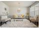 Cozy living room featuring a plush white rug, modern decor, comfortable seating, and a window at 383 Crestbrook Ln, Dallas, GA 30157