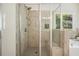 Tiled shower featuring glass doors, shower head, seat, and a window at 383 Crestbrook Ln, Dallas, GA 30157
