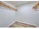 Walk in closet offers built in shelving and luxury vinyl plank flooring at 450 Collier Ridge Nw Dr, Atlanta, GA 30318