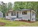 Charming renovated brick home featuring a new roof, stylish black trim, and landscaping at 450 Collier Ridge Nw Dr, Atlanta, GA 30318
