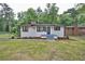 Charming white brick home with black trim, modern windows, and a well-manicured front lawn at 450 Collier Ridge Nw Dr, Atlanta, GA 30318