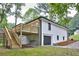 Rear exterior of the house featuring a wooden deck, stairs, and a garage door at 450 Collier Ridge Nw Dr, Atlanta, GA 30318
