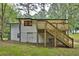 Rear exterior view of the two-story house shows the wooden deck and stairs to the backyard at 450 Collier Ridge Nw Dr, Atlanta, GA 30318
