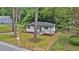 A charming home with freshly manicured lawn and landscaping and a 'For Sale' sign at 450 Collier Ridge Nw Dr, Atlanta, GA 30318