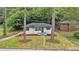 A charming home with freshly manicured lawn and landscaping shows great curb appeal at 450 Collier Ridge Nw Dr, Atlanta, GA 30318
