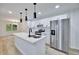 Bright kitchen features quartz countertops, a large island, stainless steel appliances and new cabinets at 450 Collier Ridge Nw Dr, Atlanta, GA 30318