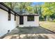 The home's freshly painted backyard features a brick patio and nice shade trees at 1207 Ellington Dr, Morrow, GA 30260