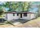 A charming backyard is featured with a brick patio and a freshly painted home at 1207 Ellington Dr, Morrow, GA 30260
