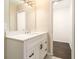 Modern bathroom featuring a sleek vanity, neutral walls, and a glimpse into an adjoining room at 1207 Ellington Dr, Morrow, GA 30260