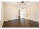 Bedroom featuring a ceiling fan, hardwood floors, and a door to the bathroom at 1207 Ellington Dr, Morrow, GA 30260