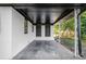 A covered patio features white columns, and access to the backyard at 1207 Ellington Dr, Morrow, GA 30260