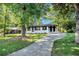 Inviting, one-story white brick home with a long driveway and lush green lawn at 1207 Ellington Dr, Morrow, GA 30260