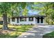 Charming single-story home featuring a freshly painted exterior, manicured lawn, and a cozy covered porch at 1207 Ellington Dr, Morrow, GA 30260