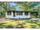 Charming one-story white brick home with a carport, well-maintained lawn, and updated exterior at 1207 Ellington Dr, Morrow, GA 30260