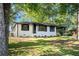 One-story white brick home with black trim, a carport, and well-manicured lawn at 1207 Ellington Dr, Morrow, GA 30260
