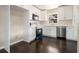 Bright kitchen featuring white cabinets, stainless steel appliances, and dark hardwood floors at 1207 Ellington Dr, Morrow, GA 30260