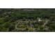 Aerial shot of a neighborhood showcases a home nestled among lush, mature trees at 4255 Hidden Meadow Circle, Sugar Hill, GA 30518