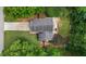 An aerial view showcases the house surrounded by lush trees in a serene, leafy neighborhood at 4255 Hidden Meadow Circle, Sugar Hill, GA 30518