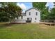 Expansive backyard featuring a well-maintained lawn, a grill, and a multi-tiered wooden deck at 4255 Hidden Meadow Circle, Sugar Hill, GA 30518