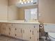 Classic bathroom with vanity, sink, toilet, and large mirror at 4255 Hidden Meadow Circle, Sugar Hill, GA 30518