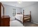 Cozy bedroom with wood furniture, natural light from the windows, and carpeted floor at 4255 Hidden Meadow Circle, Sugar Hill, GA 30518