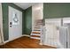 Entryway with hardwood floors, white trim staircase, and neutral paint, leading to a bright interior at 4255 Hidden Meadow Circle, Sugar Hill, GA 30518