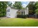 Classic two-story home with a vibrant yellow front door, a well-kept lawn, and a two-car garage at 4255 Hidden Meadow Circle, Sugar Hill, GA 30518