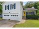 Charming two-story home with an attached two-car garage, covered porch, and well manicured landscaping at 4255 Hidden Meadow Circle, Sugar Hill, GA 30518