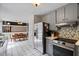 Well-lit kitchen with stainless steel appliances, ample storage, and tiled floors at 4255 Hidden Meadow Circle, Sugar Hill, GA 30518