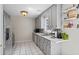 Kitchen with gray cabinets, white countertops, tile floors, and a stainless steel refrigerator at 4255 Hidden Meadow Circle, Sugar Hill, GA 30518
