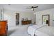 Large main bedroom with carpet, fan, closet, and furniture at 4255 Hidden Meadow Circle, Sugar Hill, GA 30518